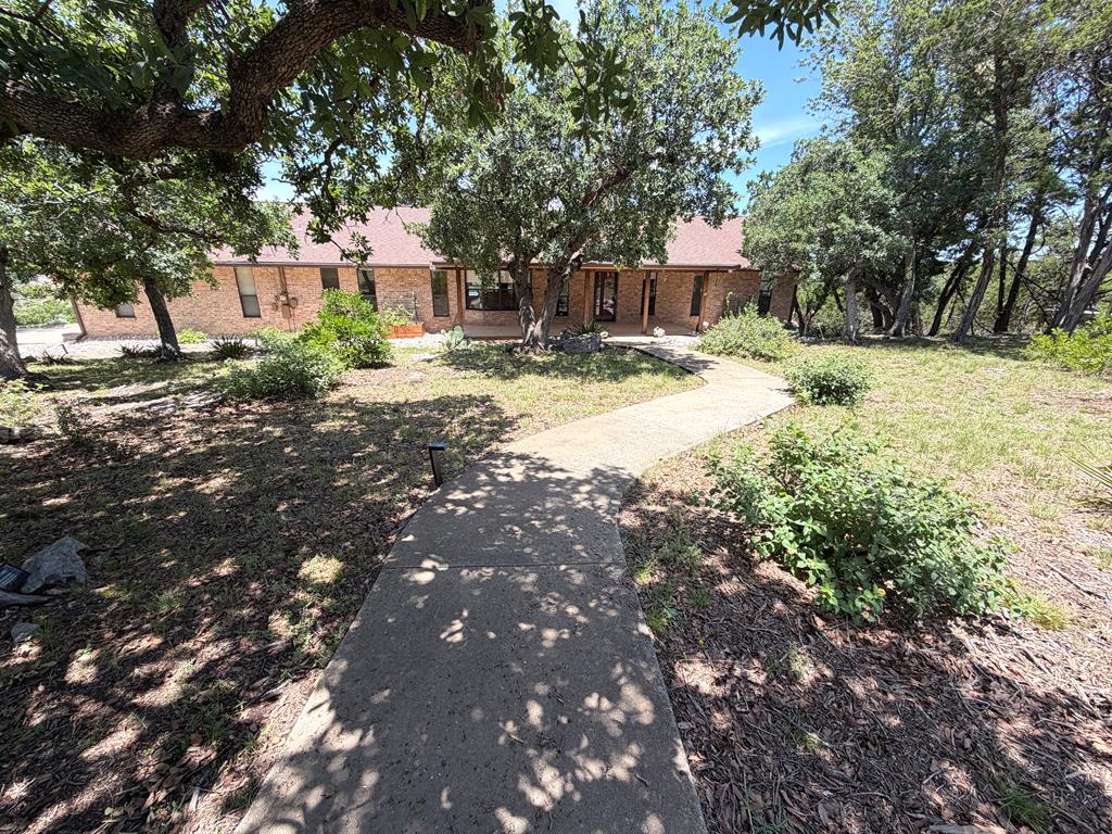 707 Rimrock Road Kerrville, TX 78028 - Photo 54 of 55 a swimming pool with outdoor seating and yard