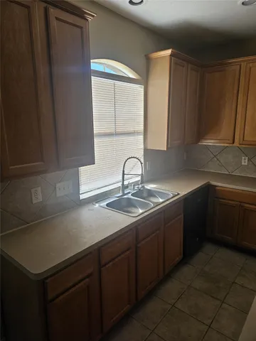 a kitchen with a sink and a refrigerator