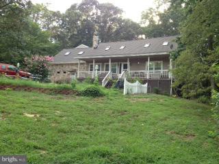 4975 Mackall Road St. Leonard, MD 20685 - Photo 1 of 1 a front view of a house with garden