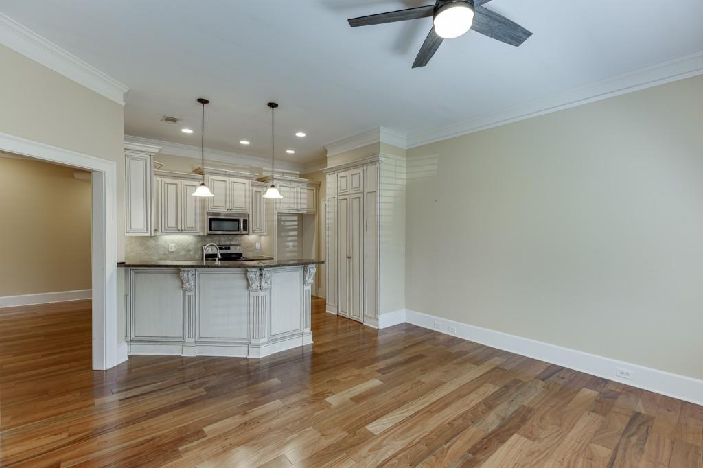 2390 Muskogee Lane Braselton, GA 30517 - Photo 13 of 40 a kitchen with kitchen island white cabinets and refrigerator