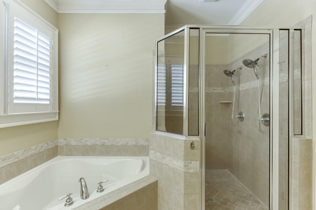 2390 Muskogee Lane Braselton, GA 30517 - Photo 22 of 40 a bathroom with a bathtub and shower