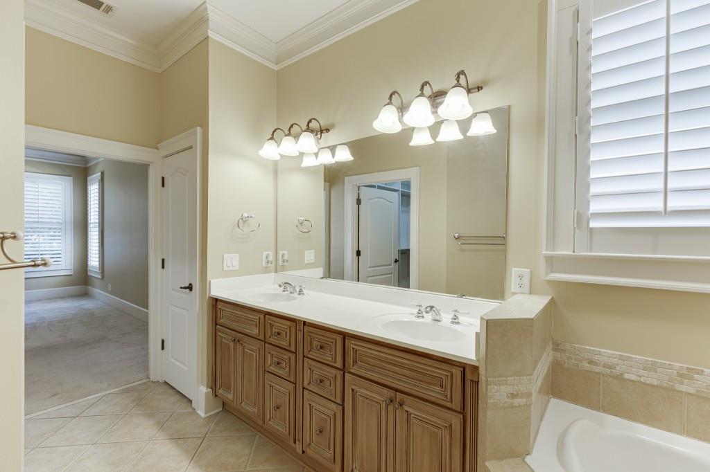 2390 Muskogee Lane Braselton, GA 30517 - Photo 23 of 40 a spacious bathroom with a double vanity sink mirror and a bathtub