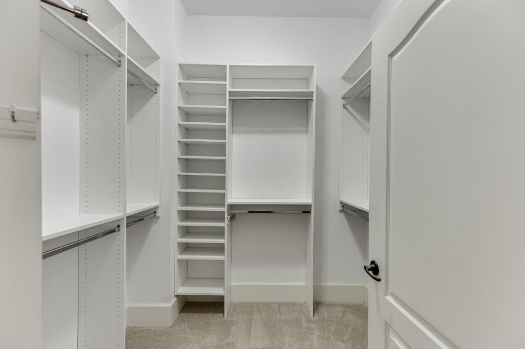 2390 Muskogee Lane Braselton, GA 30517 - Photo 24 of 40 a view of walk in closet with empty racks