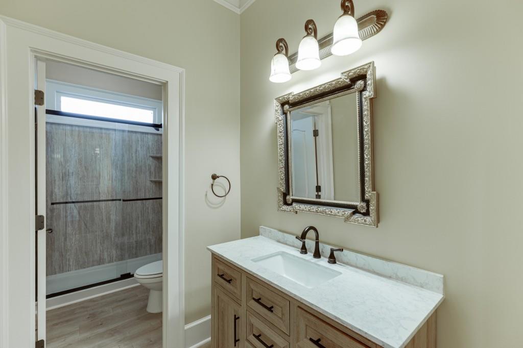 2390 Muskogee Lane Braselton, GA 30517 - Photo 27 of 40 a bathroom with a sink vanity and a mirror