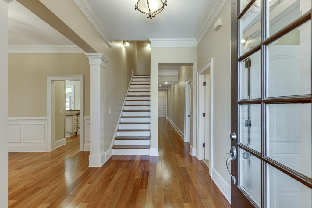 2390 Muskogee Lane Braselton, GA 30517 - Photo 3 of 40 a view of a hallway with wooden floor and staircase