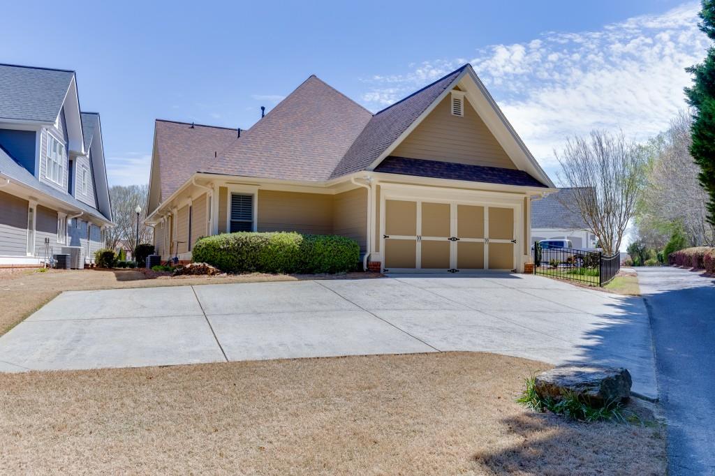2390 Muskogee Lane Braselton, GA 30517 - Photo 38 of 40 a front view of a house with a yard and a garage