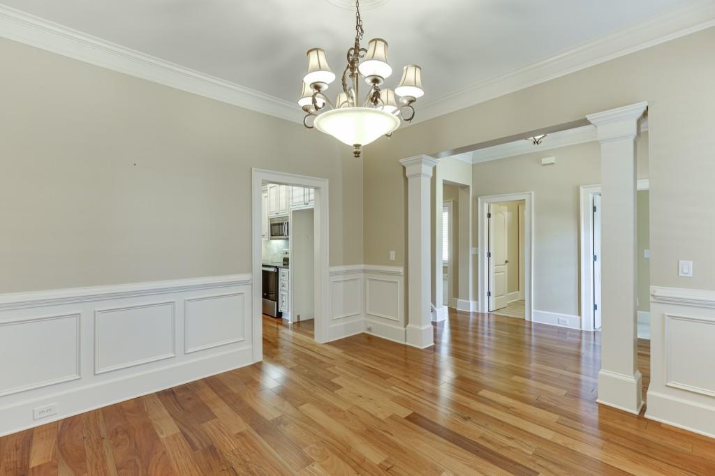 2390 Muskogee Lane Braselton, GA 30517 - Photo 5 of 40 a view of a hallway with wooden floor and chandelier