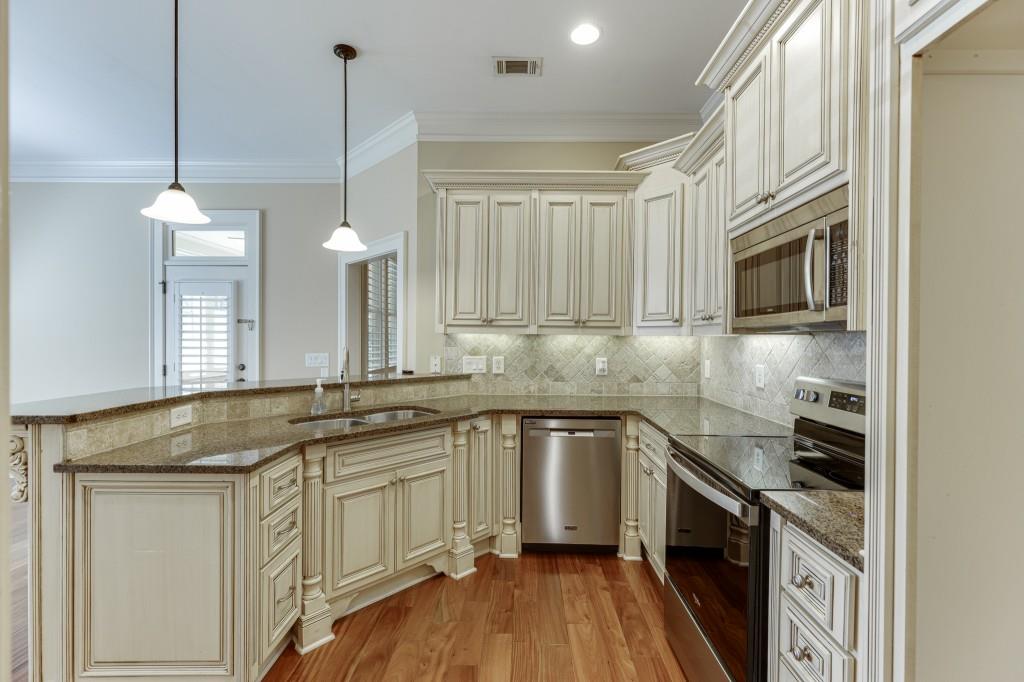 2390 Muskogee Lane Braselton, GA 30517 - Photo 7 of 40 a kitchen with stainless steel appliances granite countertop a sink a stove and a wooden floors
