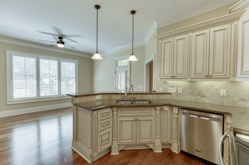 2390 Muskogee Lane Braselton, GA 30517 - Photo 8 of 40 a kitchen that has a sink a stove and cabinets