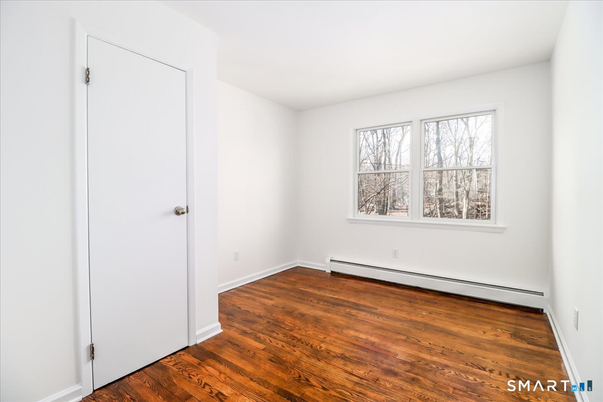 8 Summit Lane Ridgefield, CT 06877 - Photo 19 of 40 a view of an empty room with wooden floor and a window