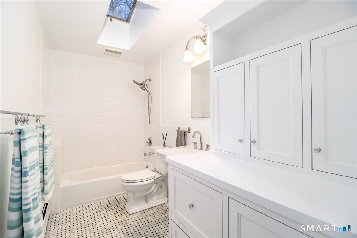 8 Summit Lane Ridgefield, CT 06877 - Photo 22 of 40 a bathroom with a sink a toilet and a bathtub