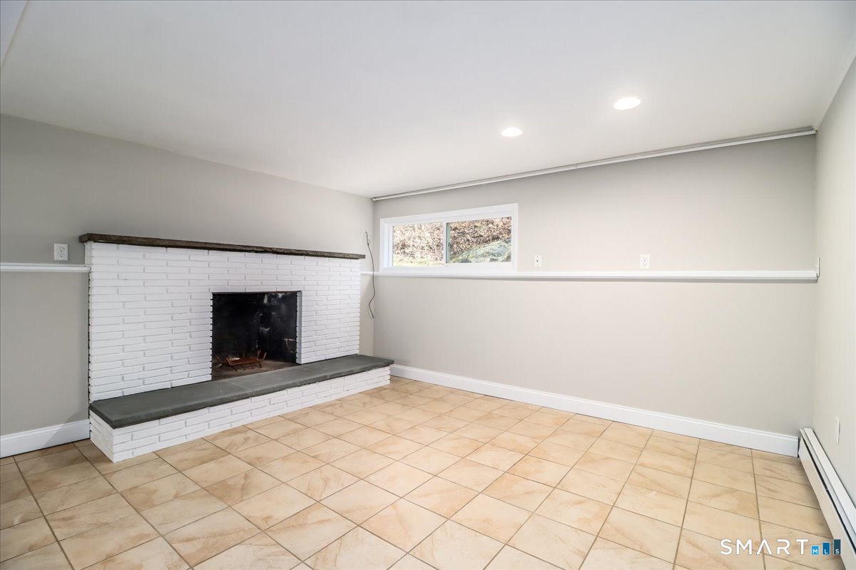 8 Summit Lane Ridgefield, CT 06877 - Photo 25 of 40 a view of an empty room with a fireplace