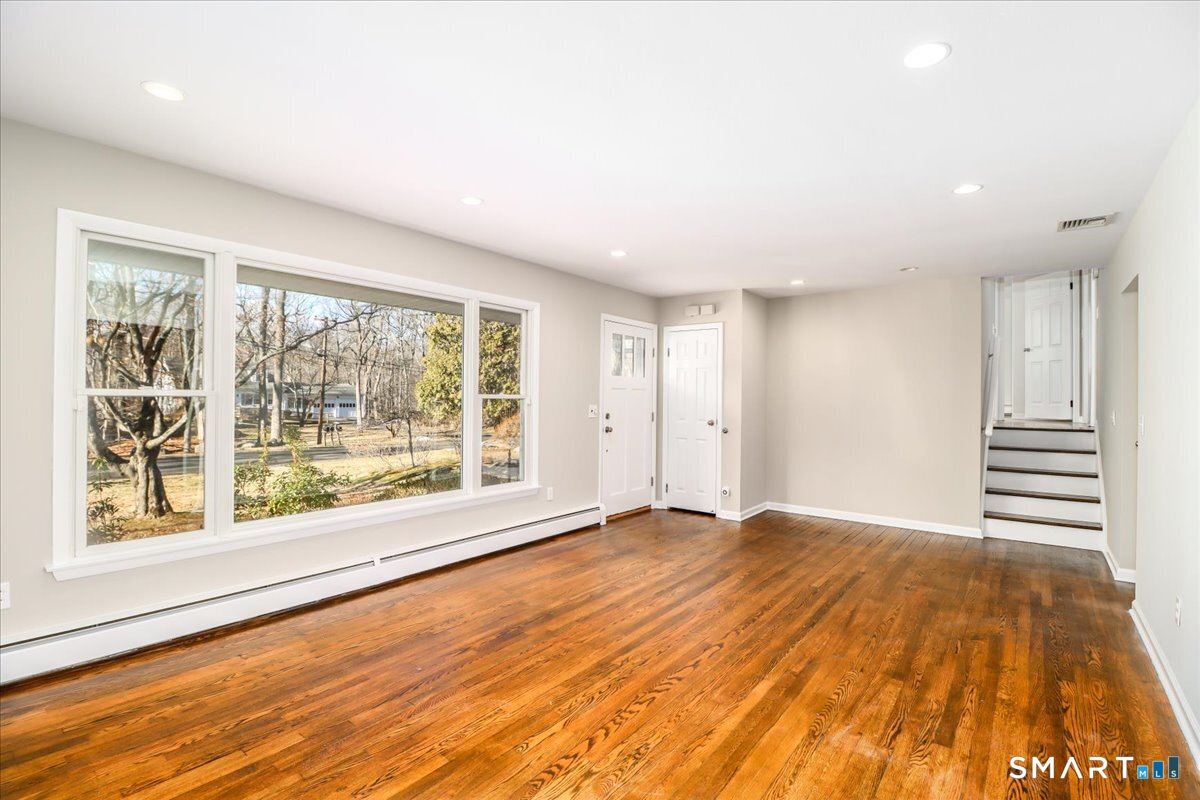 8 Summit Lane Ridgefield, CT 06877 - Photo 3 of 40 a view of an empty room with a window and wooden floor