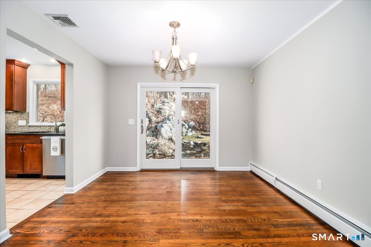 8 Summit Lane Ridgefield, CT 06877 - Photo 5 of 40 a view of a room with window wooden floor and a kitchen space