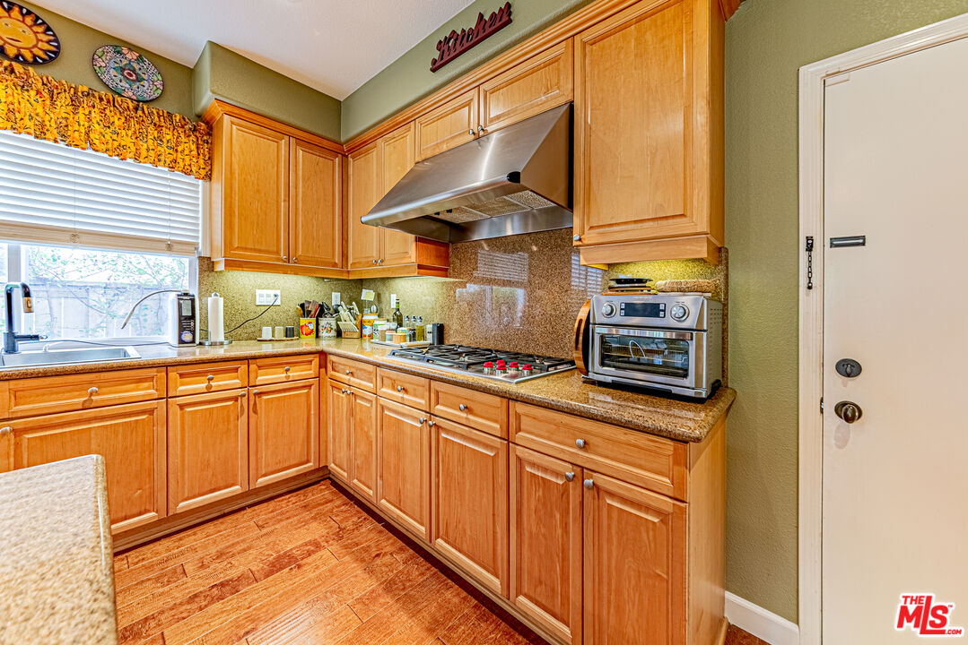 23208 Maple Avenue Torrance, CA 90505 - Photo 18 of 62 a kitchen with stainless steel appliances granite countertop a sink and cabinets