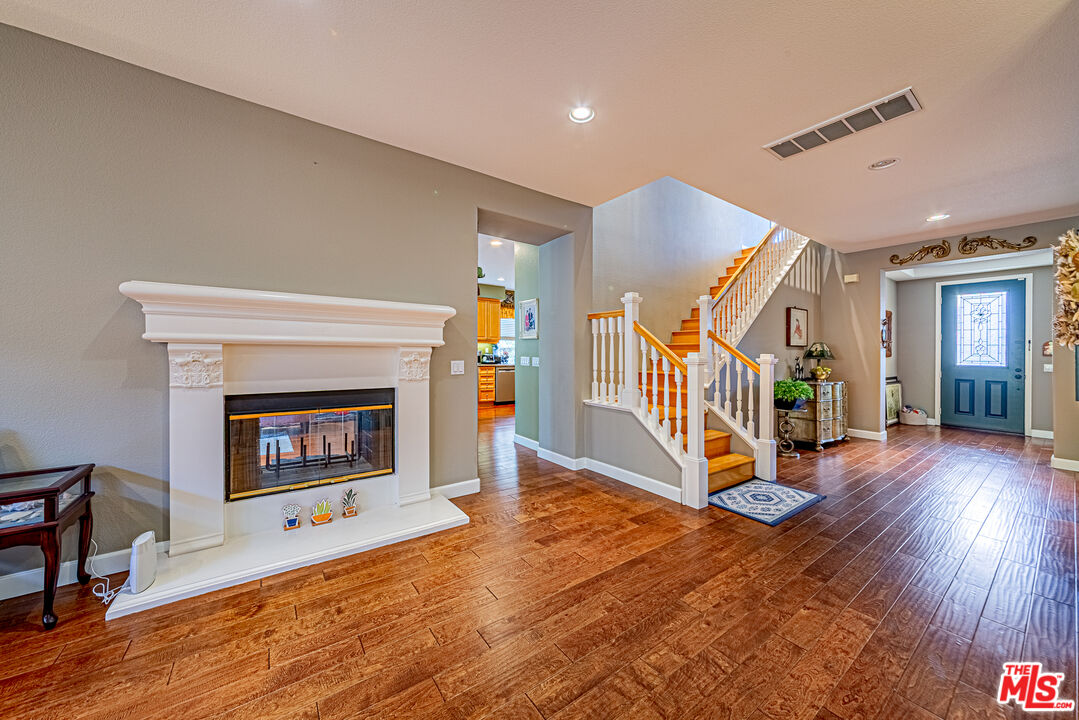 23208 Maple Avenue Torrance, CA 90505 - Photo 25 of 62 a view of a livingroom with wooden floor and a fireplace