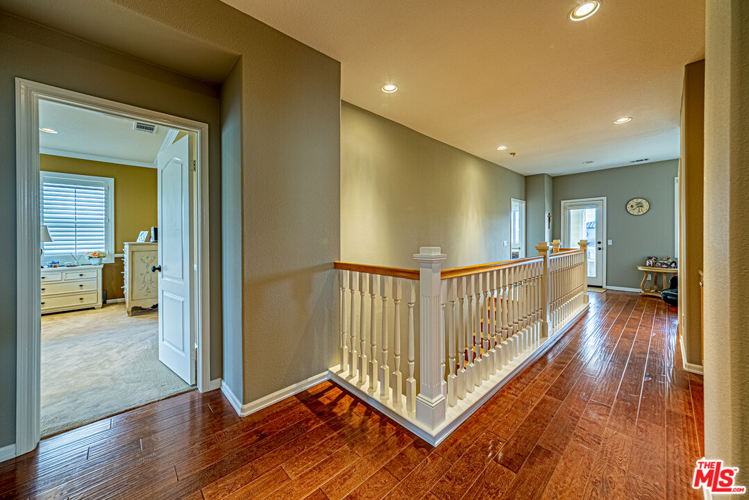23208 Maple Avenue Torrance, CA 90505 - Photo 33 of 62 a view of a hallway with wooden floor and stairs