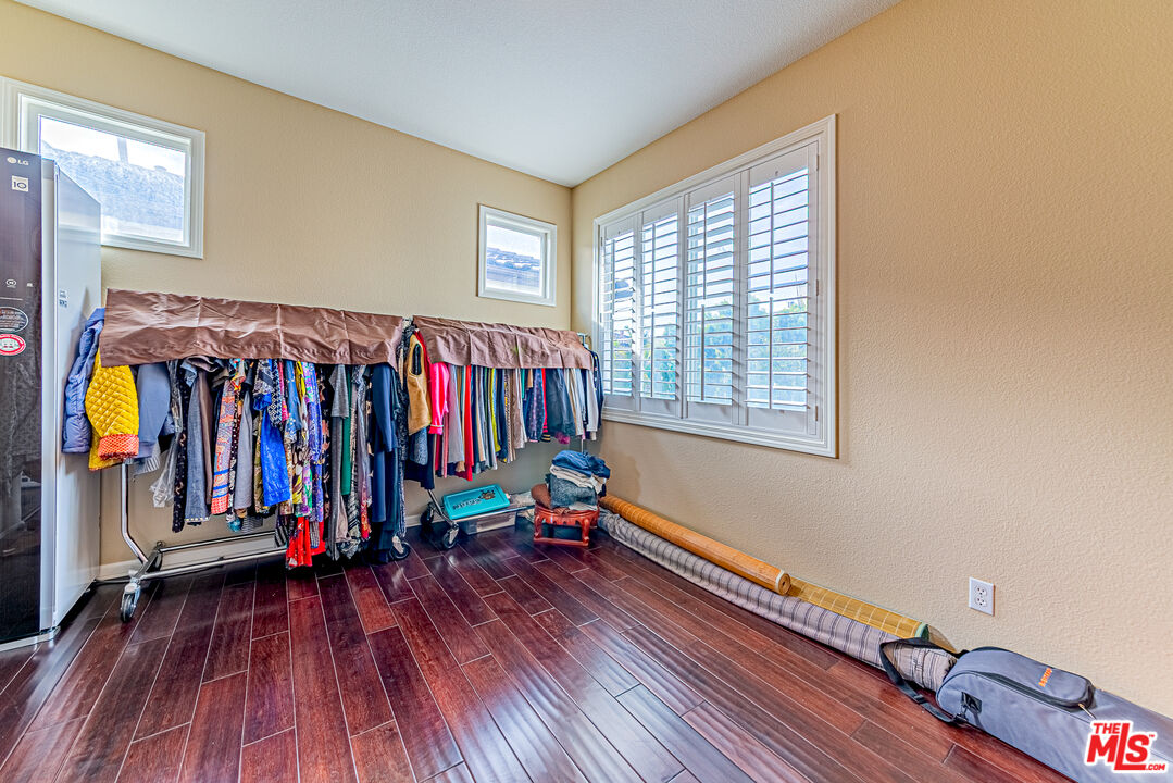 23208 Maple Avenue Torrance, CA 90505 - Photo 35 of 62 a view of walk in closet with clothes and shoes