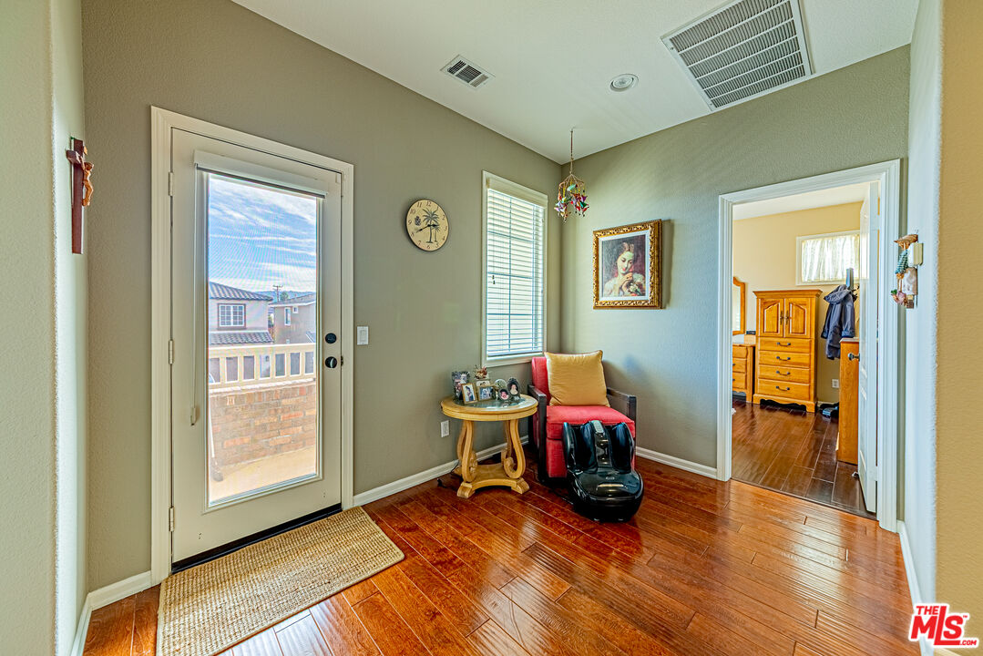 23208 Maple Avenue Torrance, CA 90505 - Photo 36 of 62 a room with furniture and wooden floor