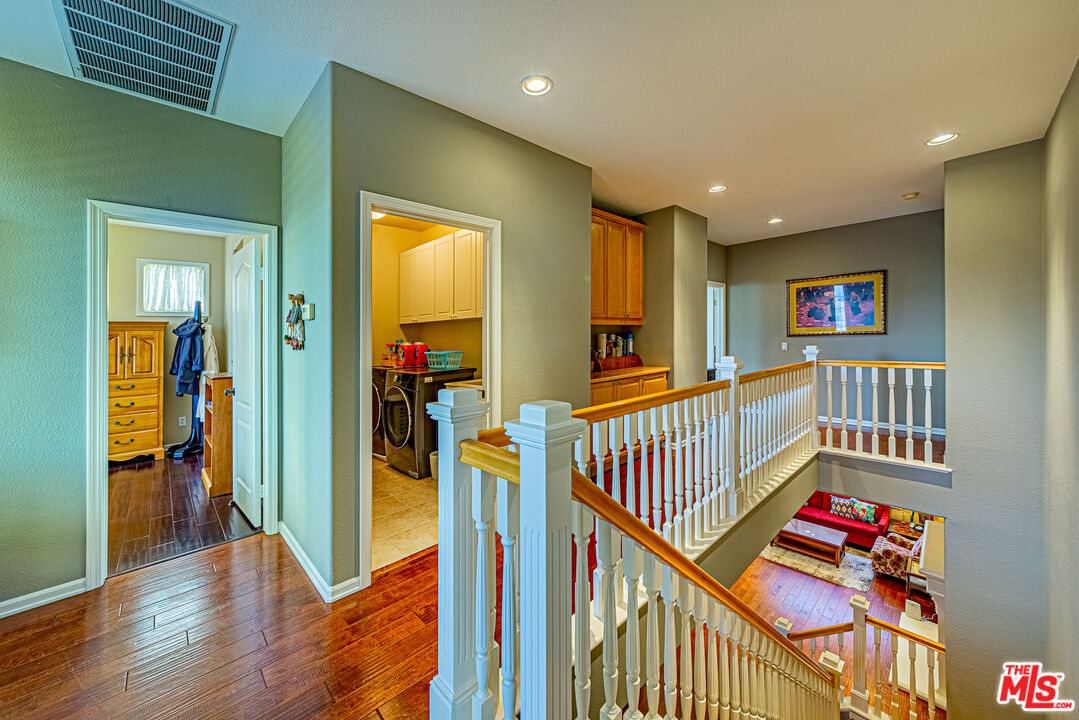 23208 Maple Avenue Torrance, CA 90505 - Photo 39 of 62 a view of a hallway with wooden floor and windows