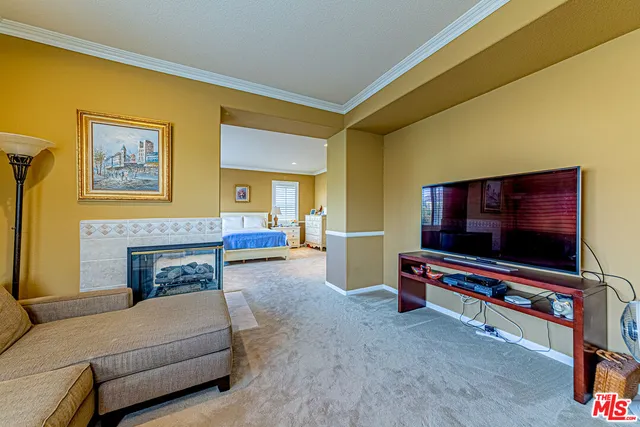 a spacious bedroom with a bed and wooden floor