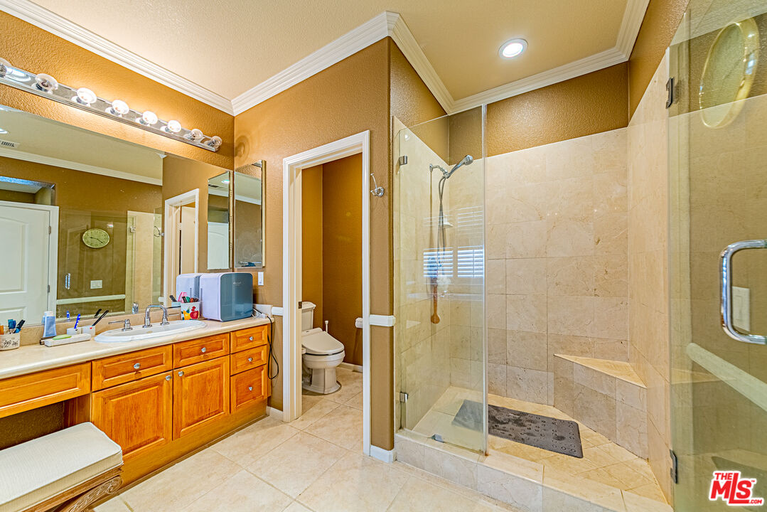23208 Maple Avenue Torrance, CA 90505 - Photo 48 of 62 a spacious bathroom with a mirror a shower and a sink