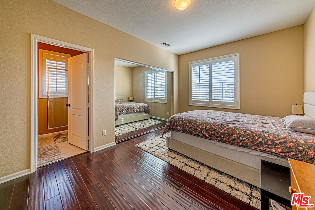 23208 Maple Avenue Torrance, CA 90505 - Photo 49 of 62 a spacious bedroom with a bed and wooden floor