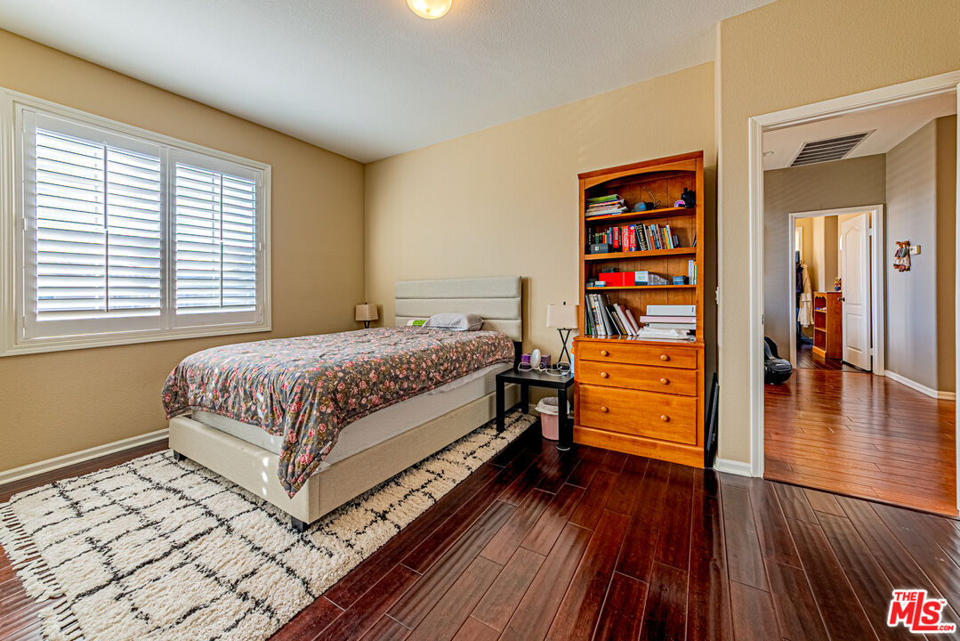 23208 Maple Avenue Torrance, CA 90505 - Photo 5 of 62 a bedroom with a bed and wooden floor