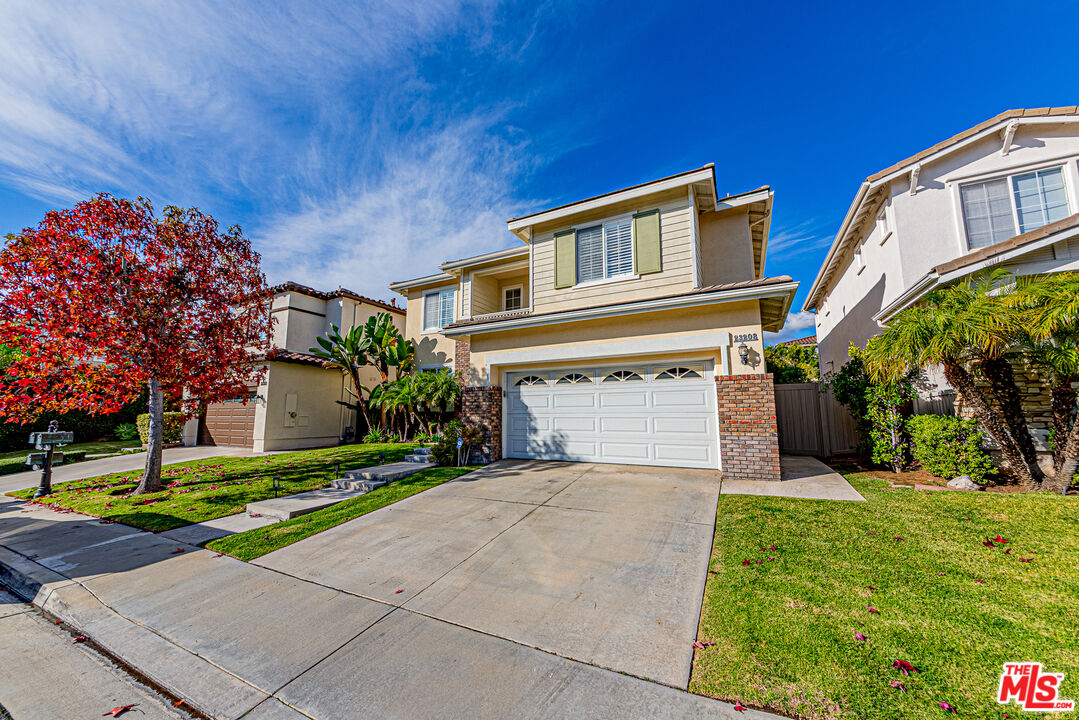 23208 Maple Avenue Torrance, CA 90505 - Photo 51 of 62 a front view of a house with a yard and garage