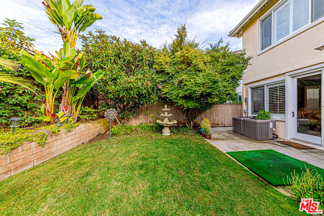 23208 Maple Avenue Torrance, CA 90505 - Photo 54 of 62 a view of a backyard with table and chairs and potted plants