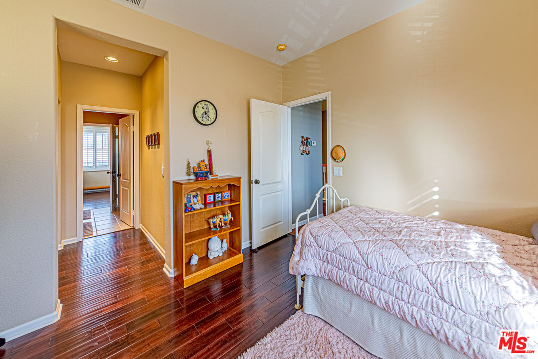 23208 Maple Avenue Torrance, CA 90505 - Photo 7 of 62 a bedroom with a bed and wooden floor