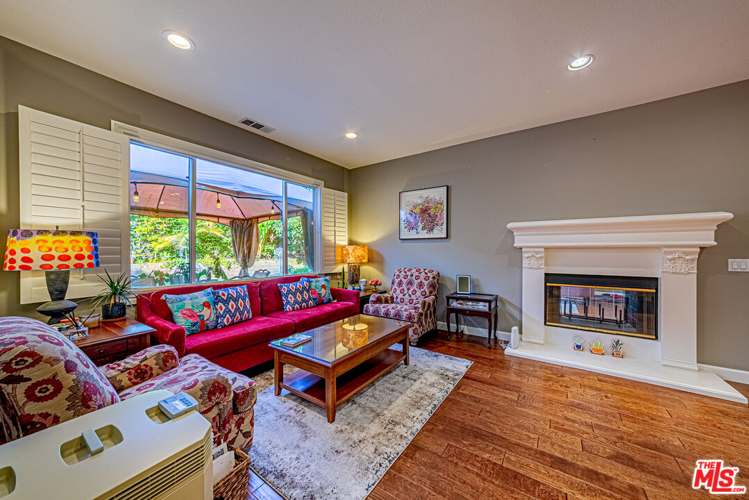 23208 Maple Avenue Torrance, CA 90505 - Photo 10 of 62 a living room with furniture a rug and a fireplace