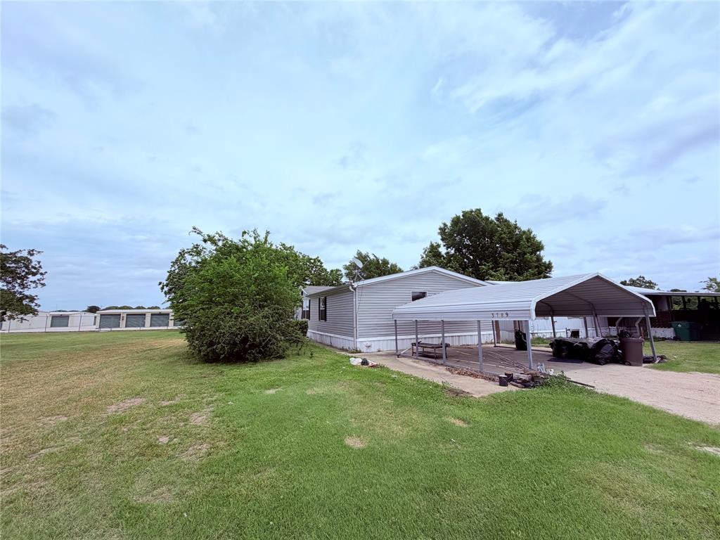 3789 Jacobs Lane Kaufman, TX 75142 - Photo 28 of 33 a aerial view of a house with table and chairs under an umbrella