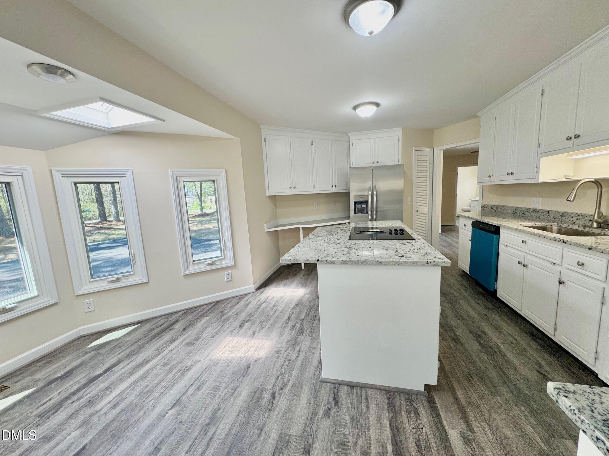 1720 Ross Mill Road Henderson, NC 27537 - Photo 18 of 42 a kitchen with granite countertop white cabinets and white appliances