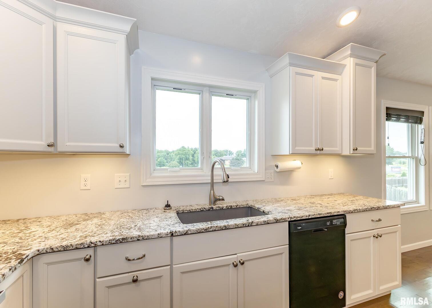 321 Pin Oak Drive Geneseo, IL 61254 - Photo 21 of 42 a kitchen with granite countertop white cabinets and a sink