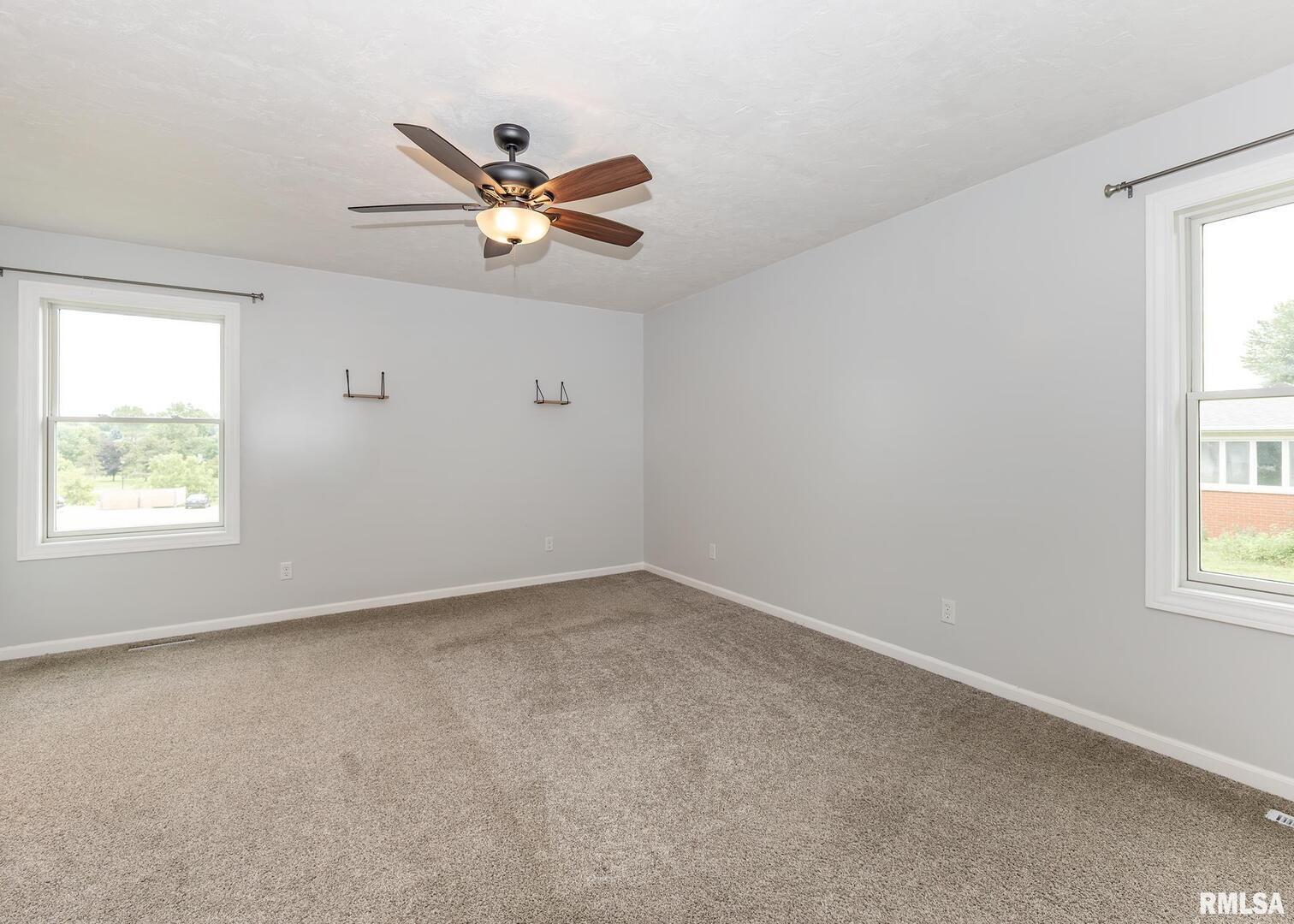 321 Pin Oak Drive Geneseo, IL 61254 - Photo 25 of 42 an empty room with a window and a fan