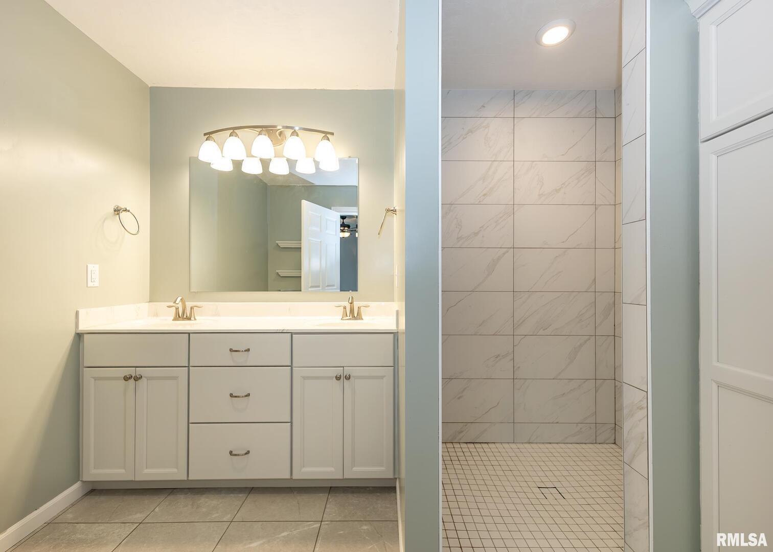 321 Pin Oak Drive Geneseo, IL 61254 - Photo 27 of 42 a bathroom with a double vanity sink and a mirror