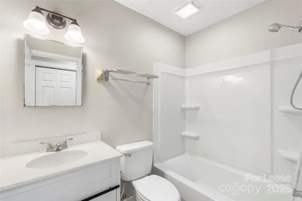 a view of a big room with wooden floor and windows