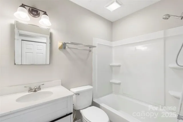 a view of a big room with wooden floor and windows