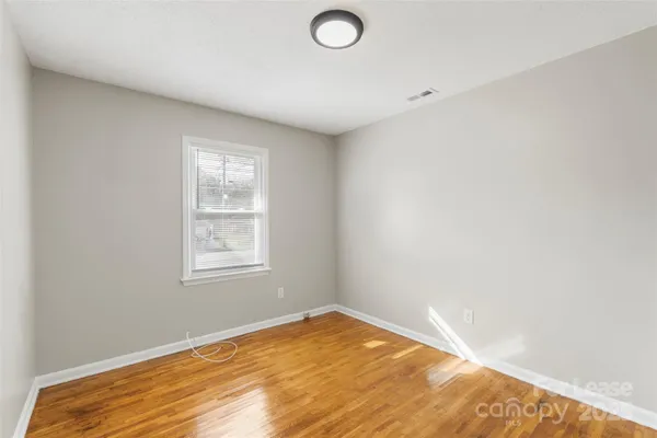 a view of an empty room and wooden floor