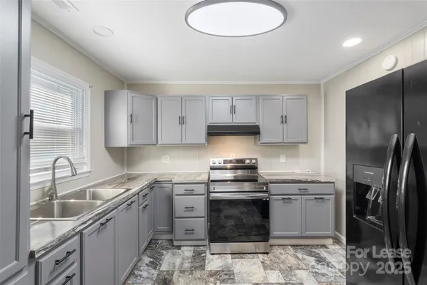 a kitchen with stainless steel appliances granite countertop a sink stove and refrigerator