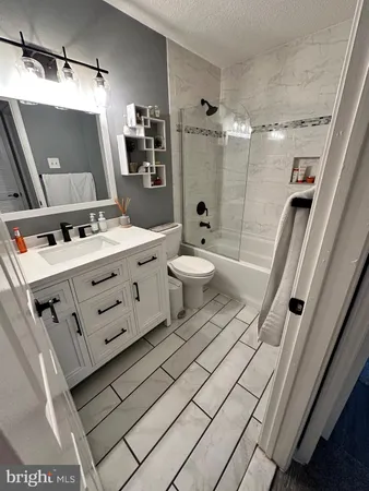 a bathroom with a double vanity sink toilet and shower