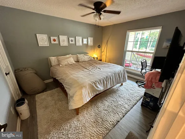 a bedroom with a bed tv and a window