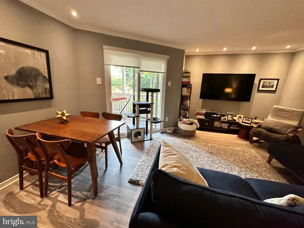 a outdoor dining space with furniture and a flat screen tv