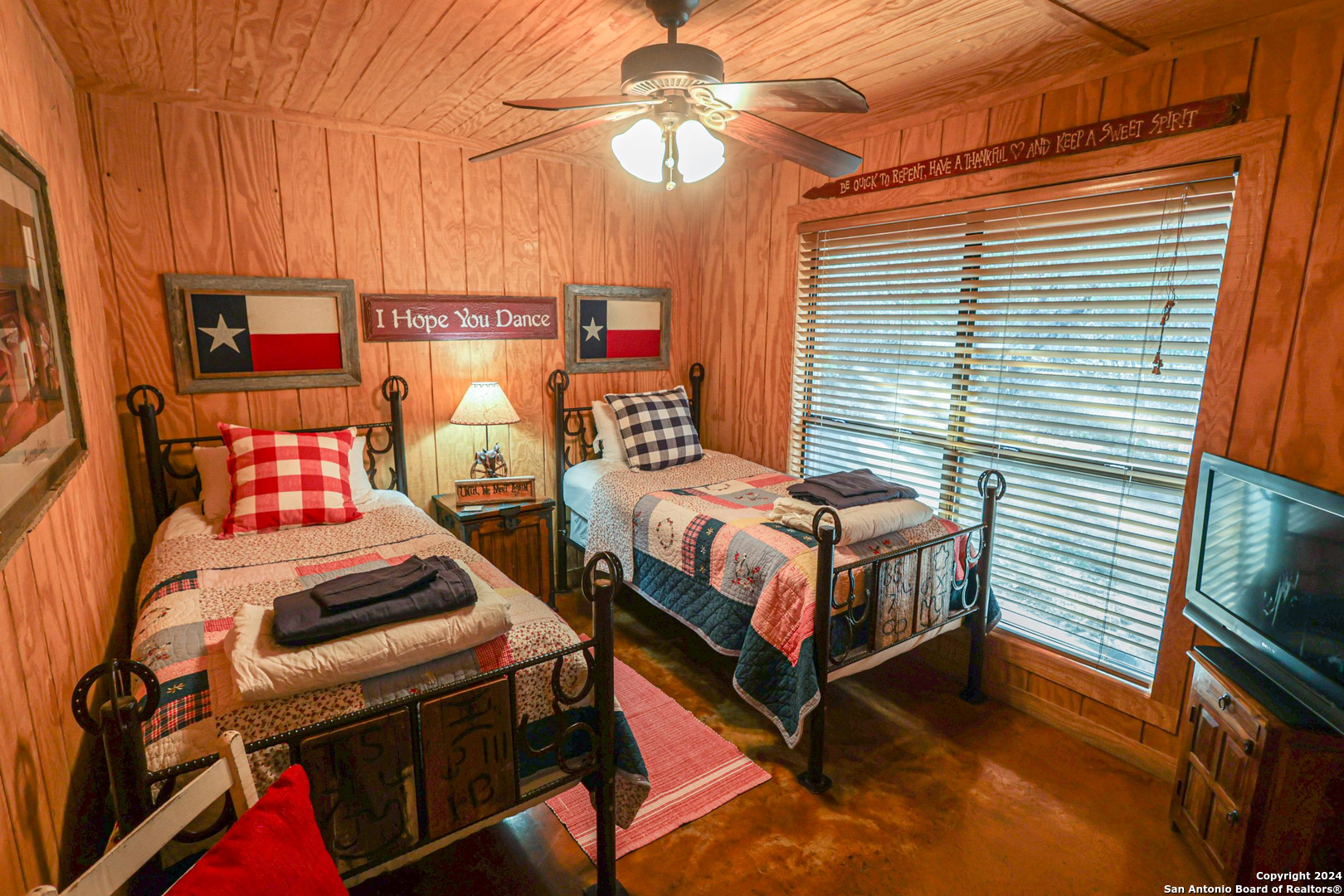1177 River Road Concan, TX 78838 - Photo 20 of 34 a bedroom with a bed and a chandelier