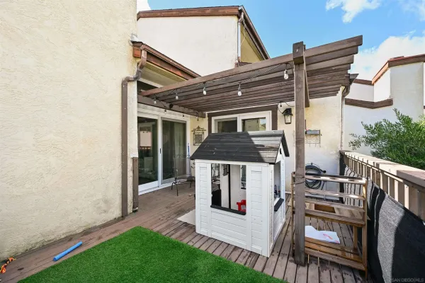 a view of a house with a yard and furniture