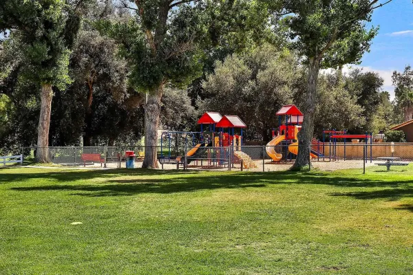 a childrens park with lots of swings and slides