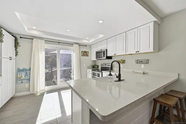 a kitchen with stainless steel appliances granite countertop a sink a stove and a refrigerator