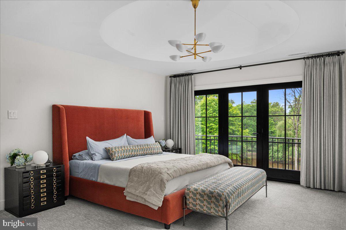 6450 Old Carversville Road New Hope, PA 18938 - Photo 40 of 89 a bedroom with a large bed and a chandelier