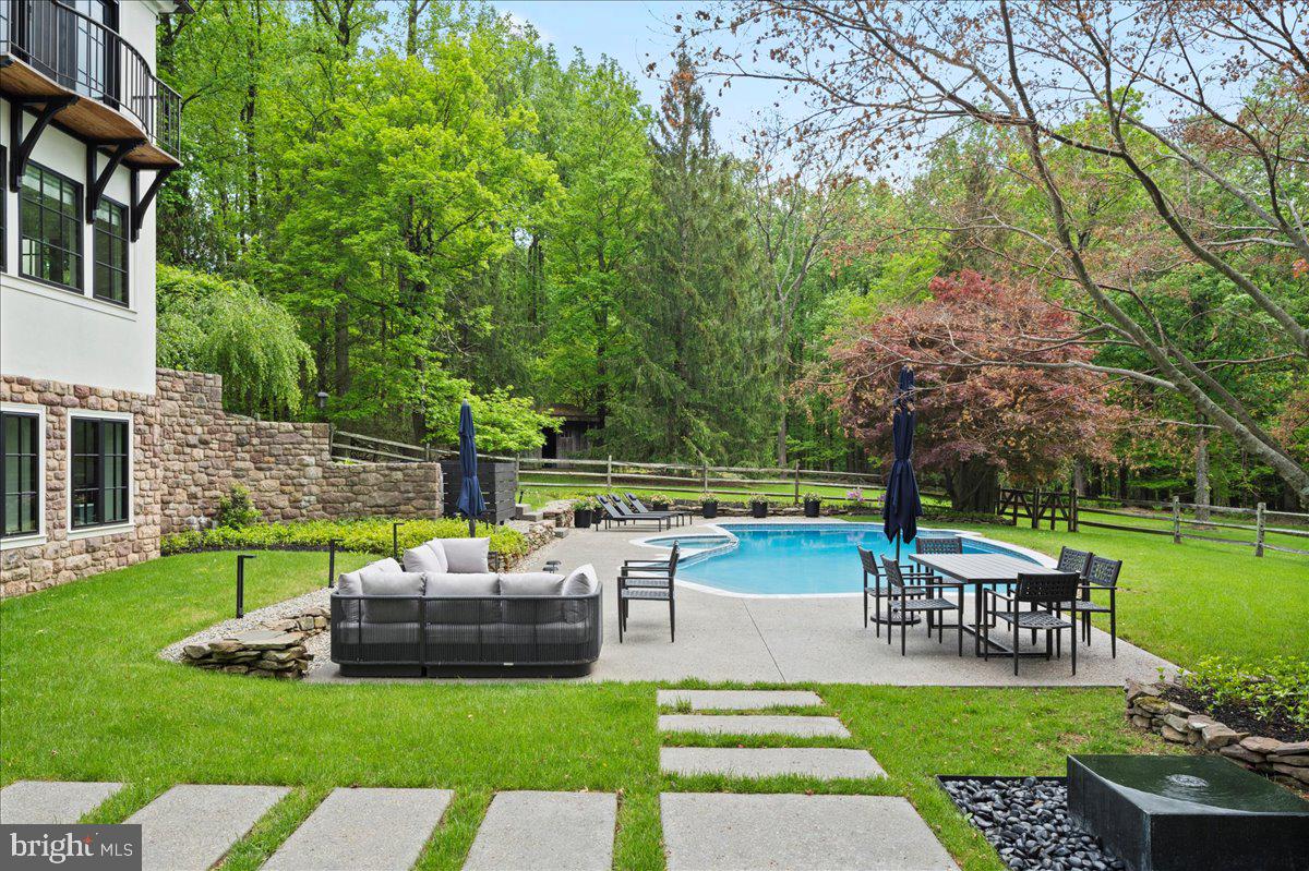 6450 Old Carversville Road New Hope, PA 18938 - Photo 70 of 89 a view of a patio with couches and a table and chairs with plants and trees